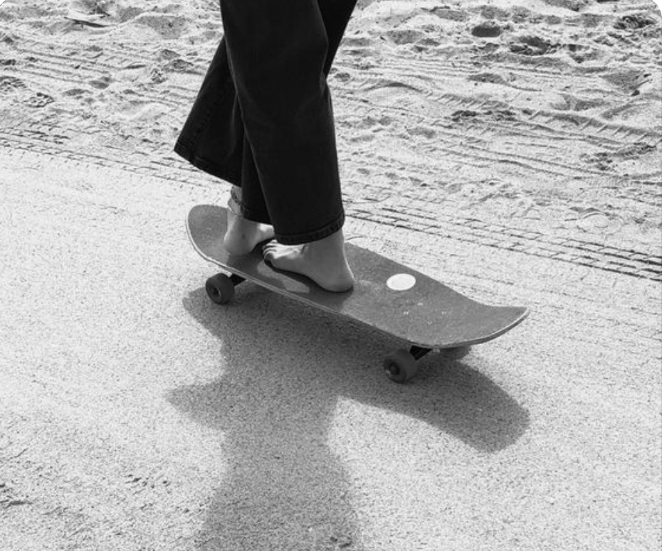 Barefoot skateboarding on a boardwalk.