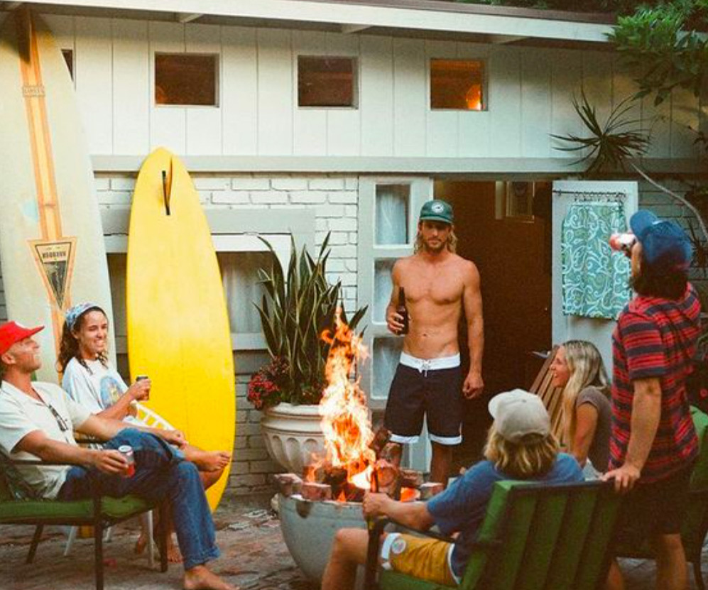 A group of happy people around a fire.